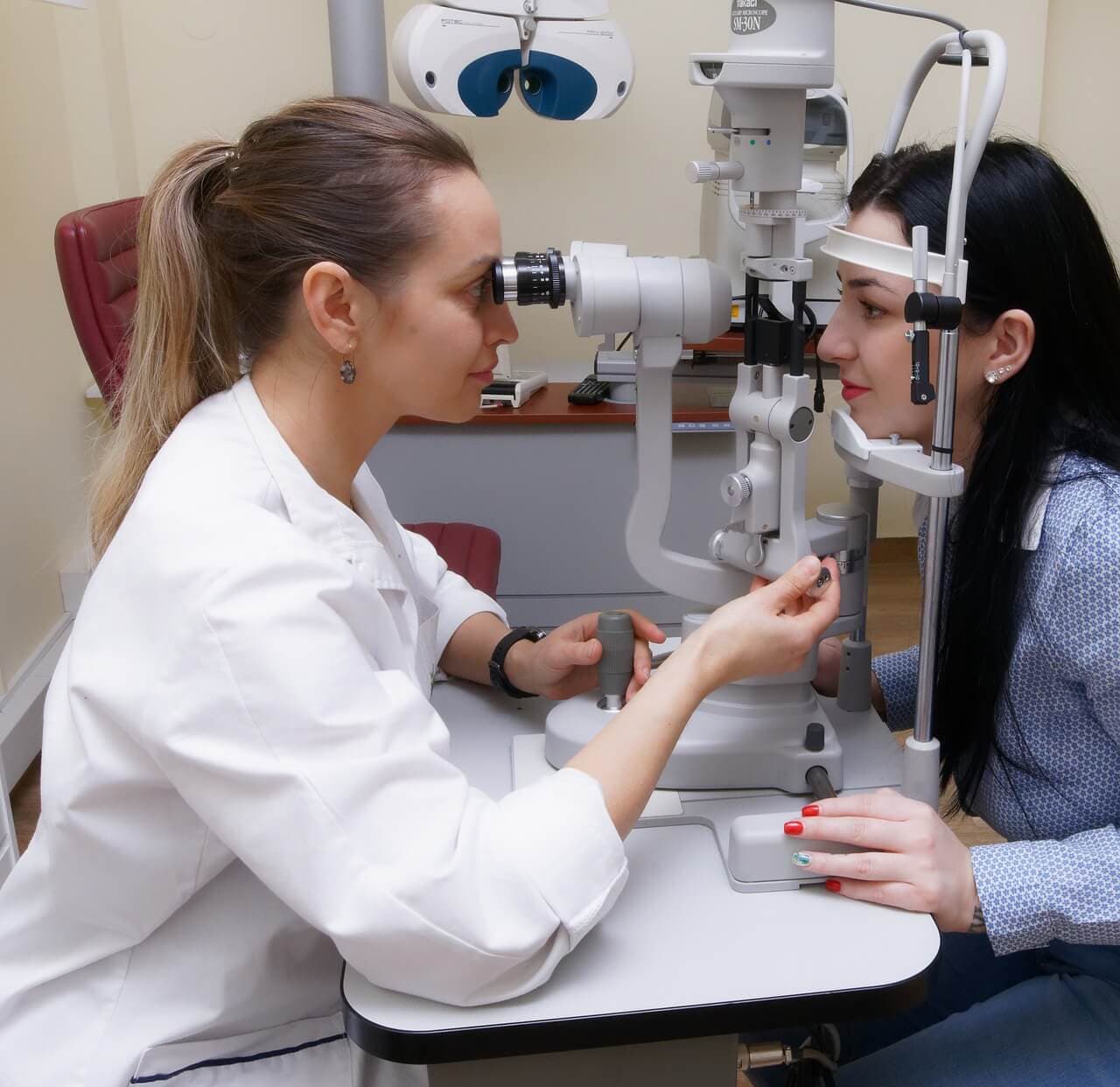 Optometrist performing a slit lamp exam on a patient at Mill Creek Family Eye Center